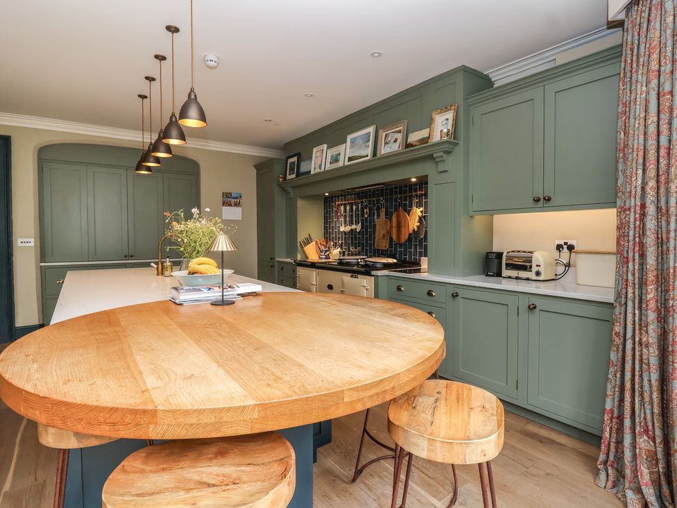 A kitchen with an island and appliances at The Old Vicarage in Merriott