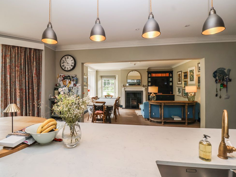 A kitchen with a dining area and a sofa at The Old Vicarage in Merriott