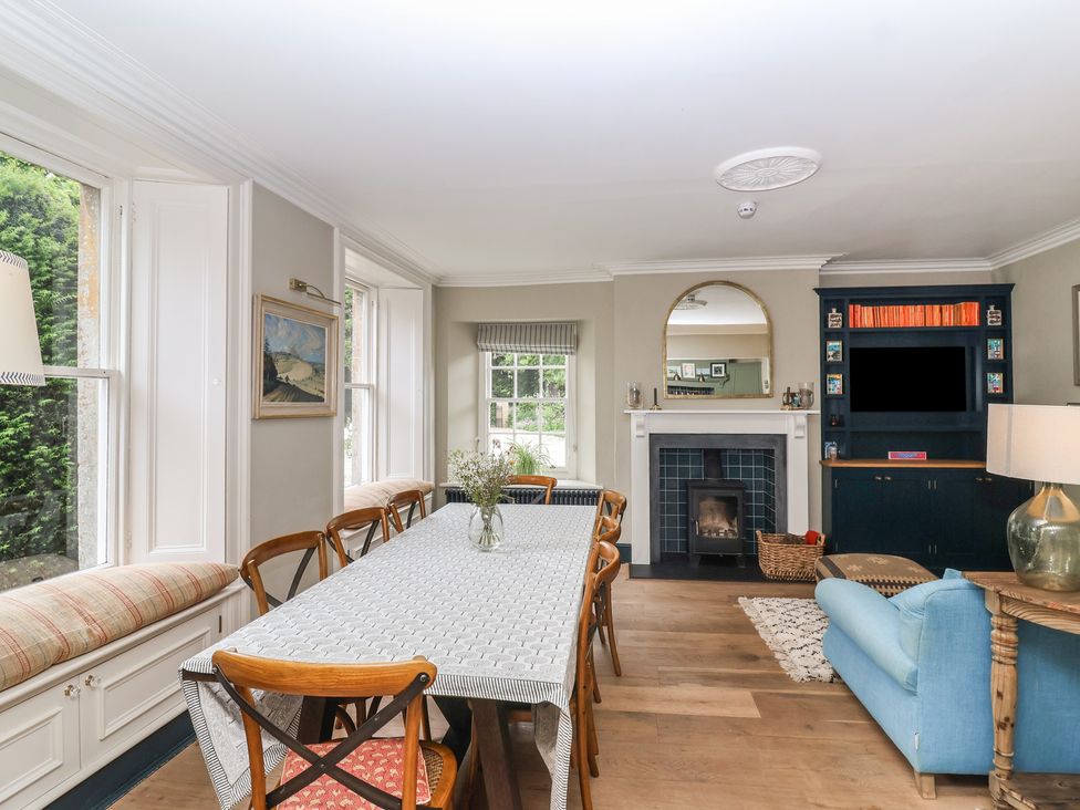 A dining room with a table and chairs at The Old Vicarage in Merriott