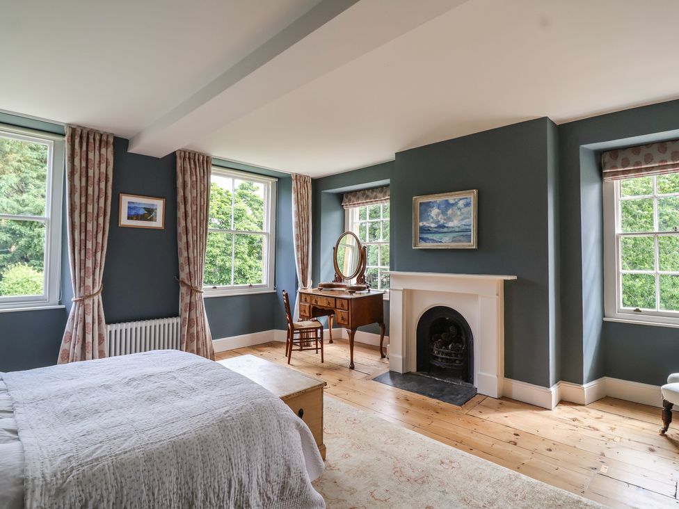 A bedroom with windows and a desk at The Old Vicarage in Merriott
