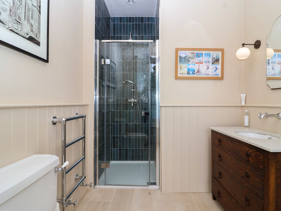 A bathroom with toilet, shower, sink and towel rail at The Old Vicarage in Merriott