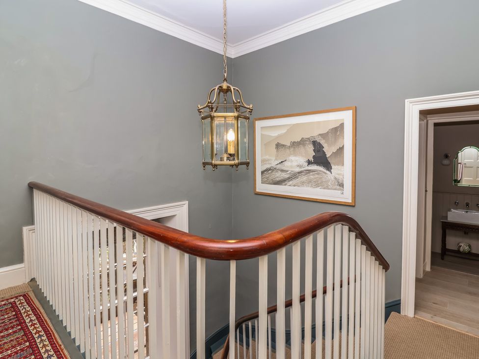 A staircase with a lantern and framed artwork at The Old Vicarage in Merriott