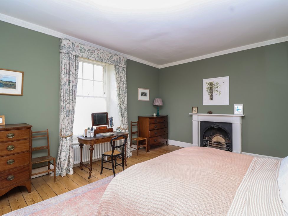 A bedroom with a bed and furniture at The Old Vicarage in Merriott