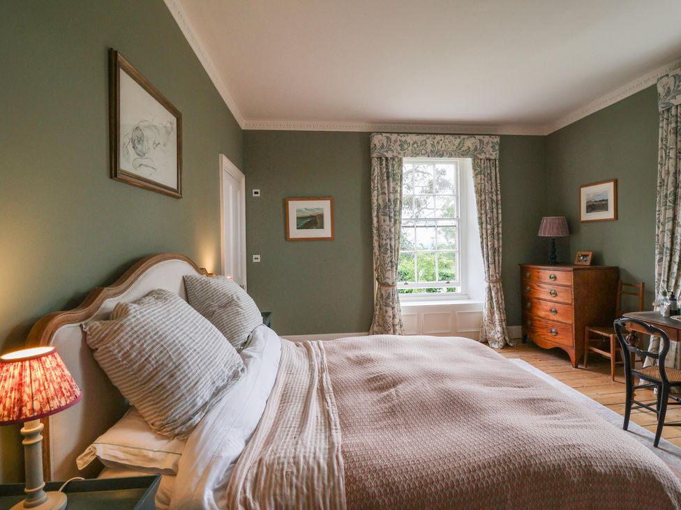 A bedroom with a bed and a dresser at The Old Vicarage in Merriott