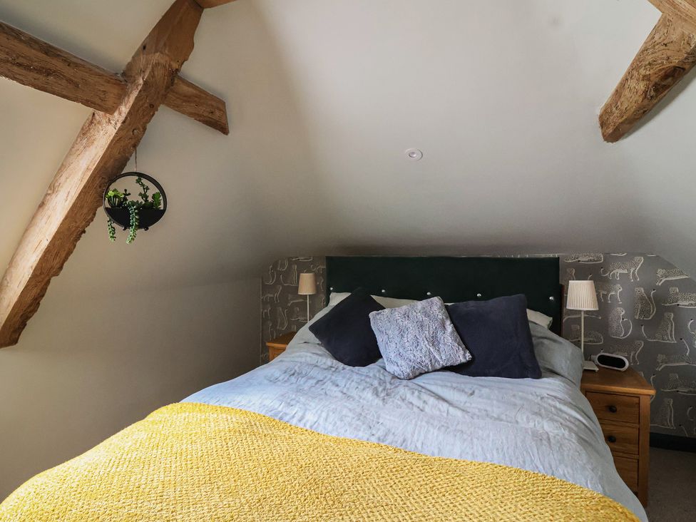 A bedroom with a bed and wall decorations at The Old Vicarage in Merriott