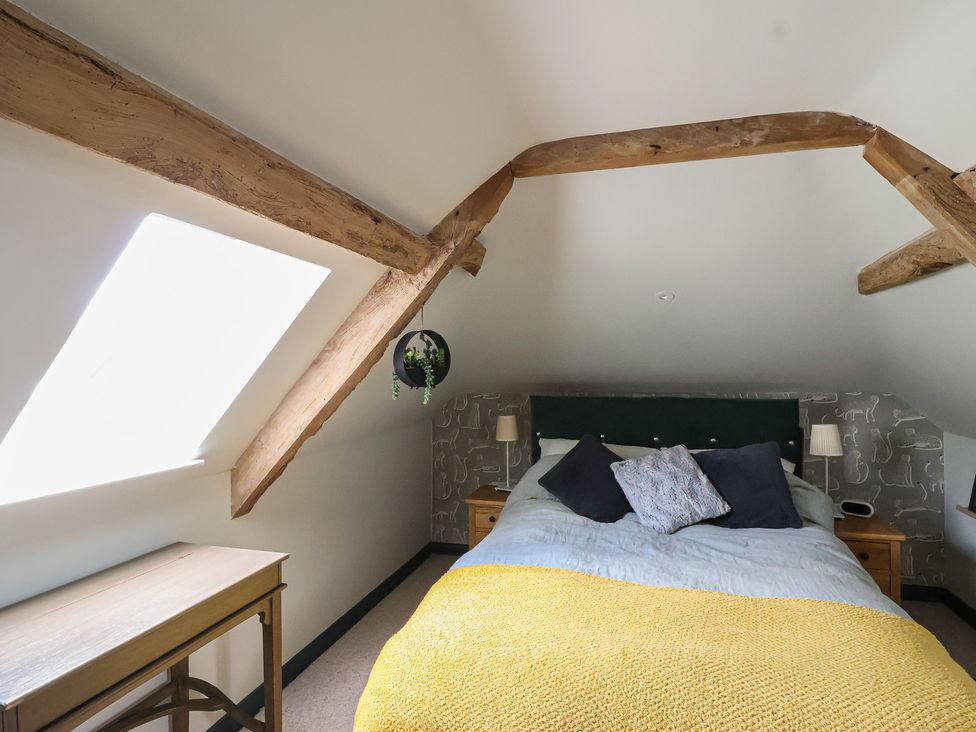 A bedroom with a bed and lamps at The Old Vicarage in Merriott
