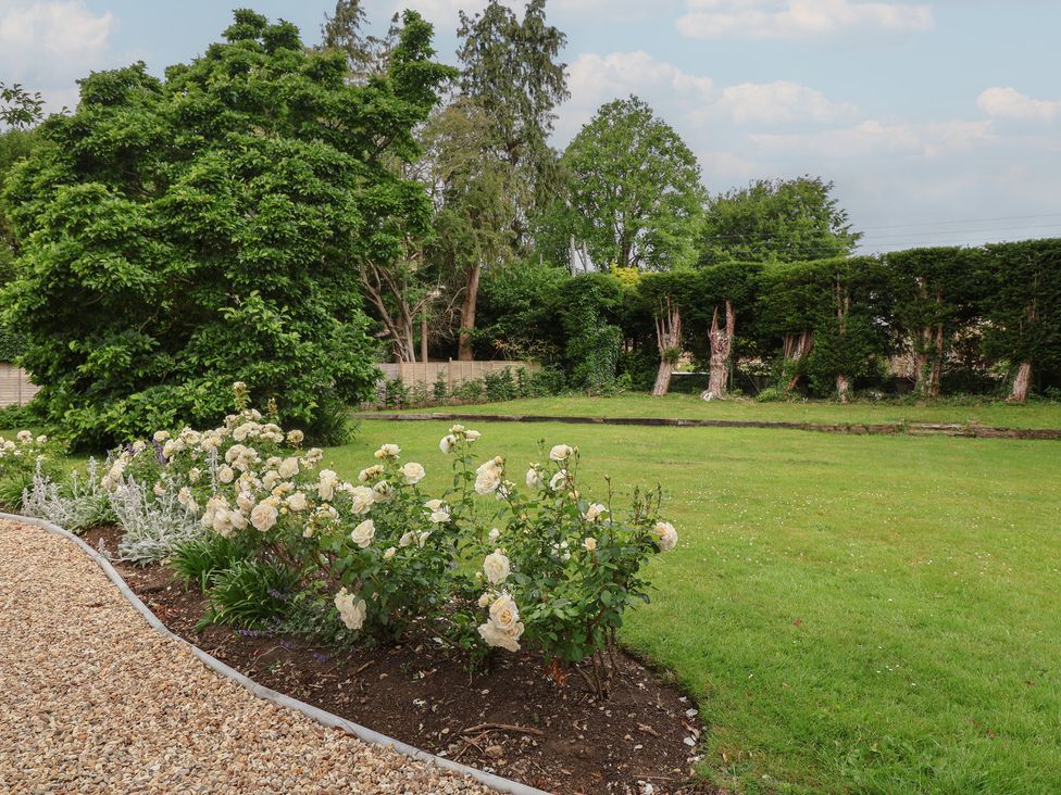 A garden with flowers and grassy area at The Old Vicarage in Merriott