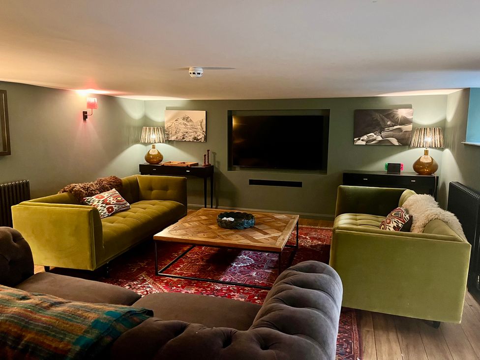 A living room with sofas and a coffee table at The Old Vicarage in Merriott