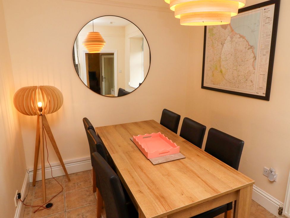 A dining room with a table and chairs at Barleycorn Cottage in Belford