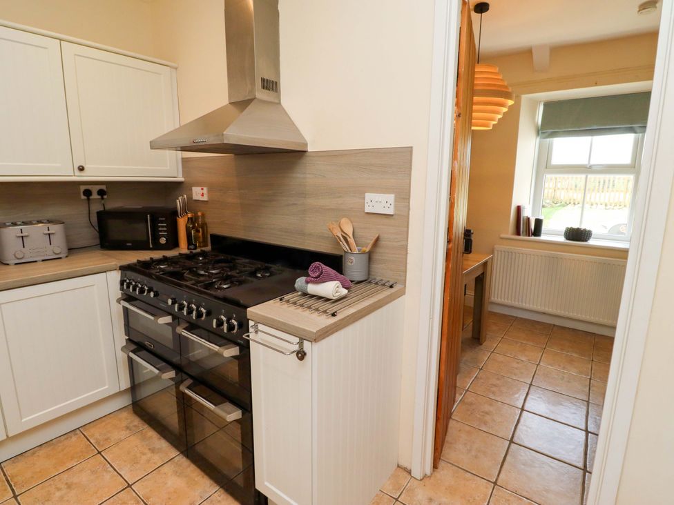 A kitchen with appliances and utensils at Barleycorn Cottage in Belford