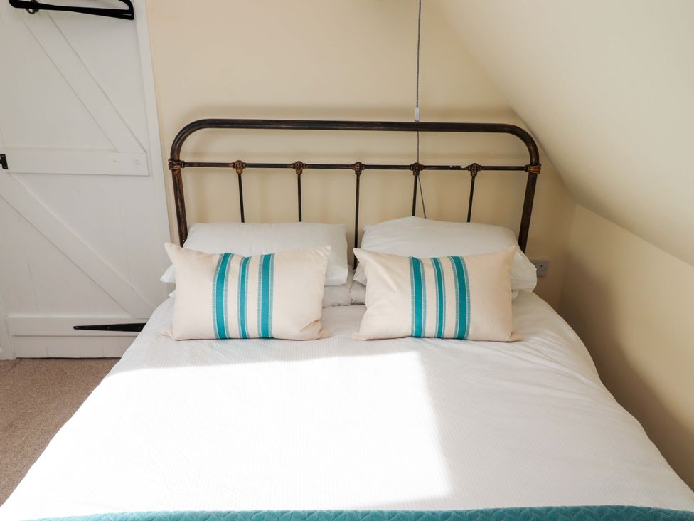 A bed with pillows in a bedroom at Barleycorn Cottage in Belford