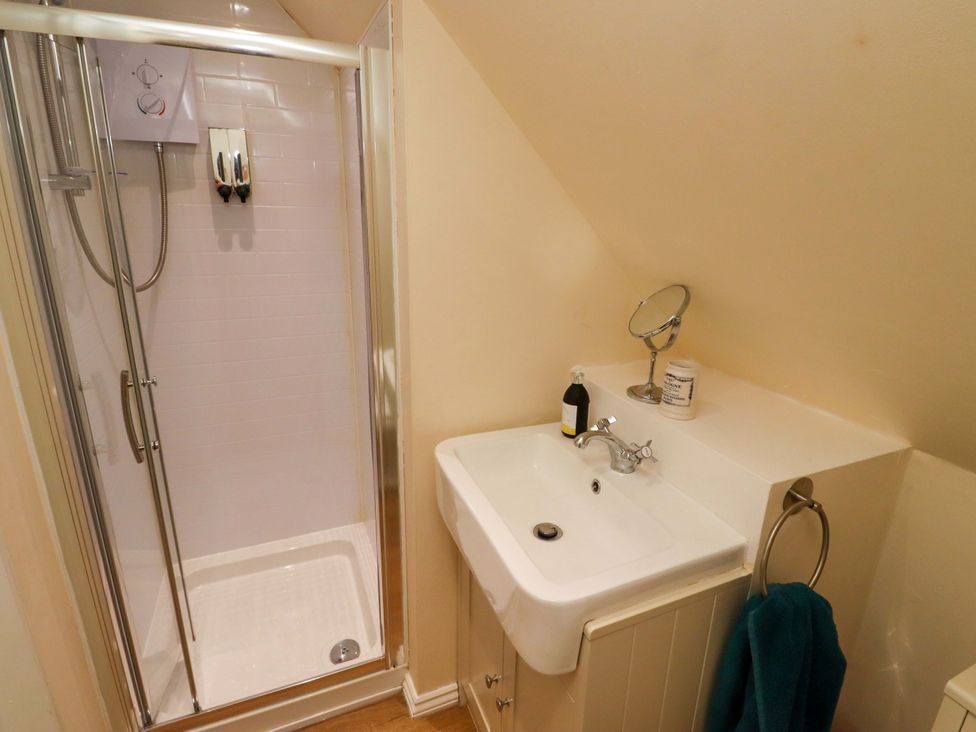 A bathroom with a shower and sink at Barleycorn Cottage in Belford