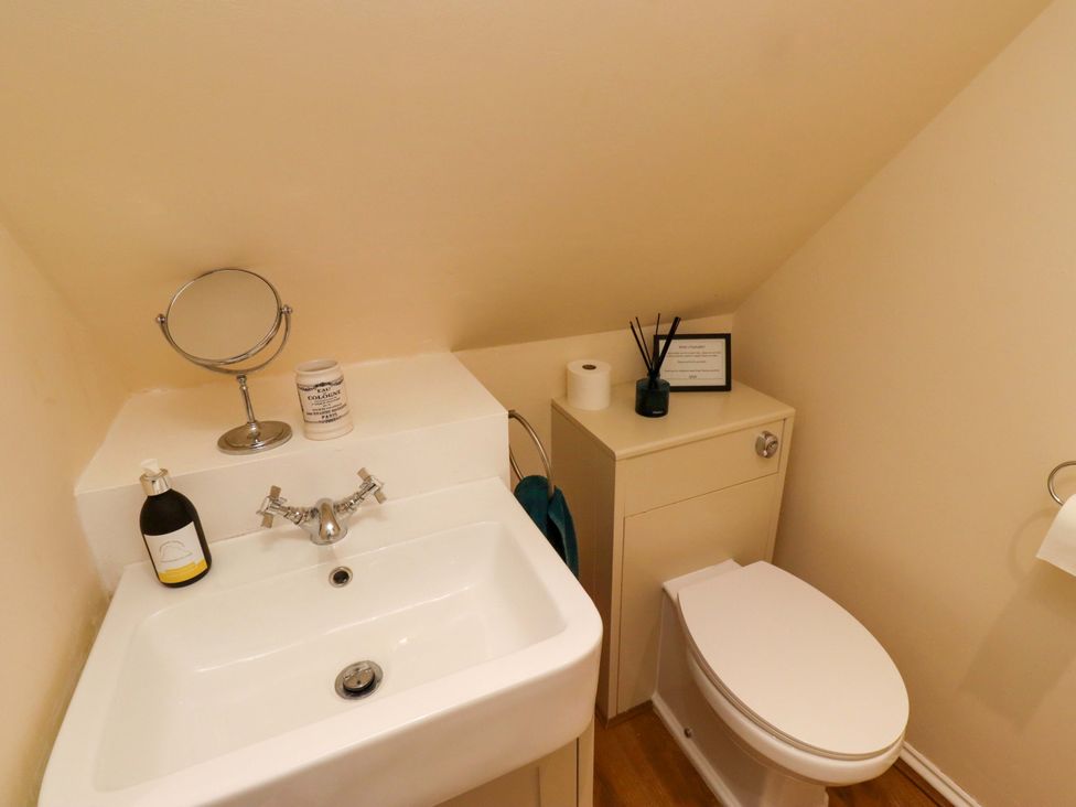 A bathroom with a sink and toilet at Barleycorn Cottage in Belford