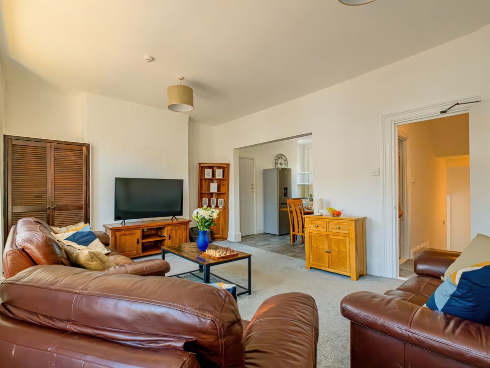 A living room with a television and coffee table at Flat 56 Newton Road Abertawe