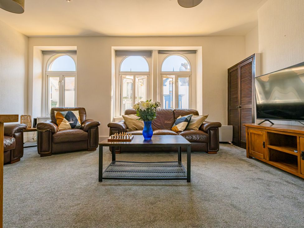 A living room with a coffee table and sofa at Flat 56 Newton Road Abertawe