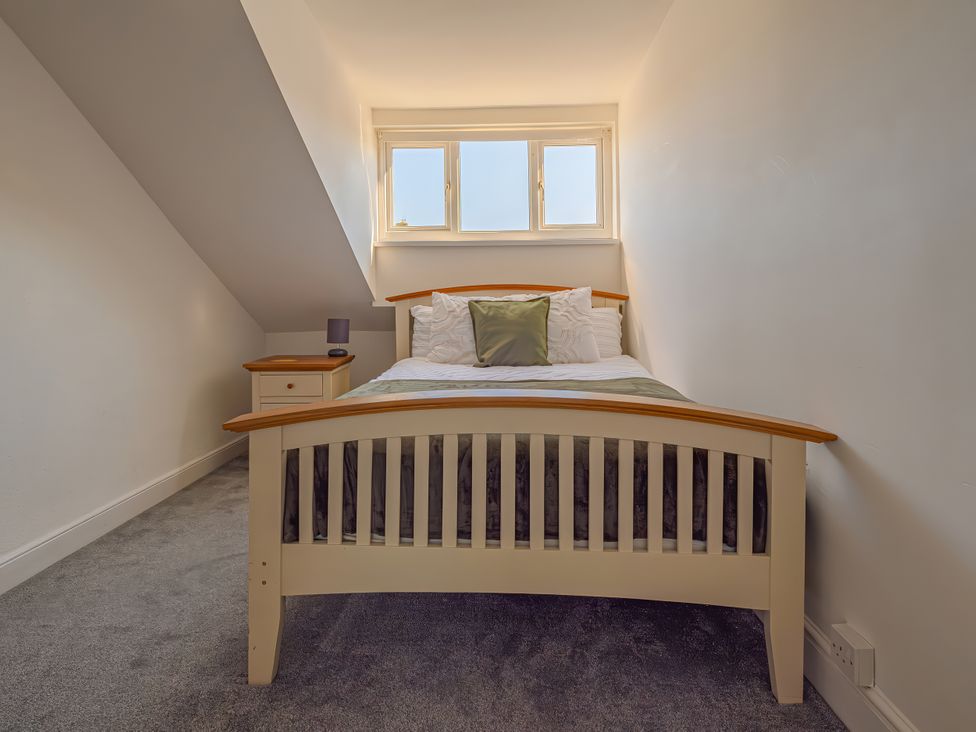 A bedroom with a bed and bedside table at Flat 56 Newton Road Abertawe