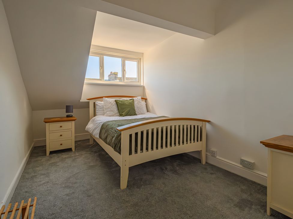 A bedroom with a bed and bedside table at Flat 56 Newton Road Abertawe