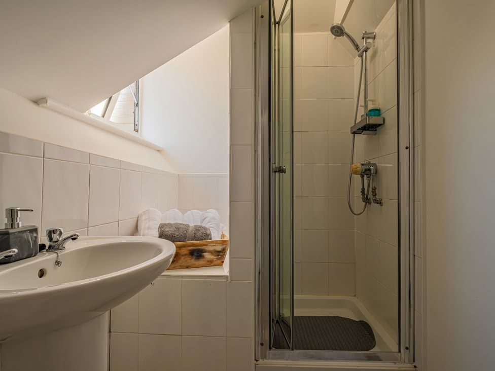 A bathroom with a shower and sink at Flat 56 Newton Road Abertawe