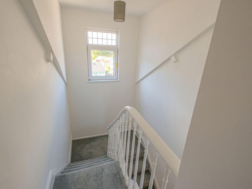 A staircase with a window at Flat 56 Newton Road Abertawe