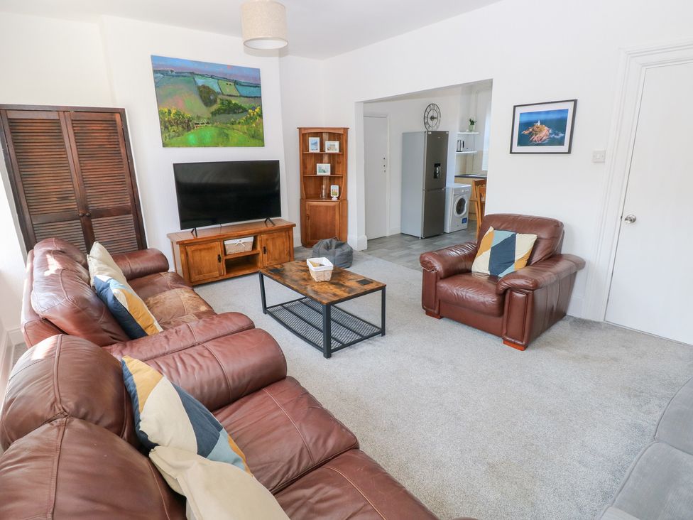 A living room with a television and sofa at Flat 56 Newton Road in Mumbles