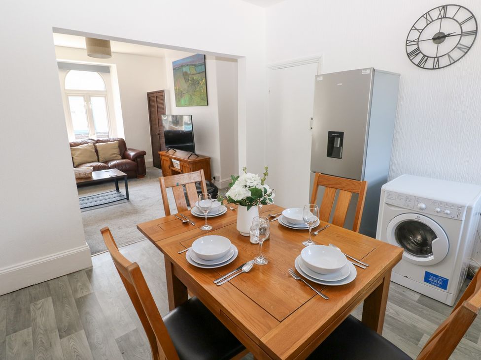 A dining room with a table set for four at Flat 56 Newton Road Mumbles
