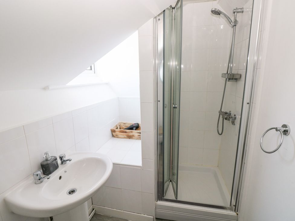 A bathroom with a sink and a shower at Flat 56 Newton Road in Mumbles