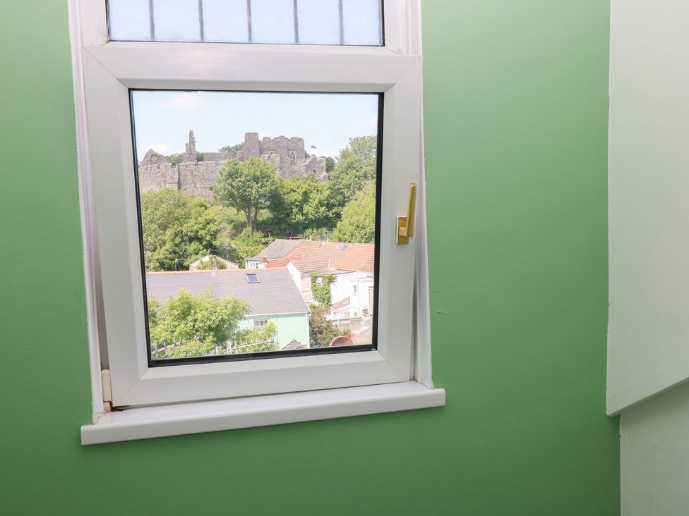 A window with a view of a castle and houses at Flat 56 Newton Road Mumbles