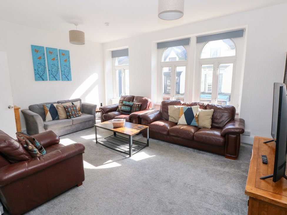 A living room with sofas and a coffee table at Castleview Coastal Comfort in Mumbles