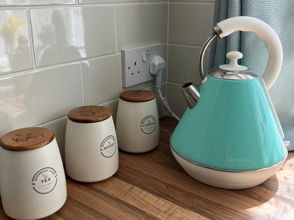 A kettle and canisters on a counter at Claire Cottage