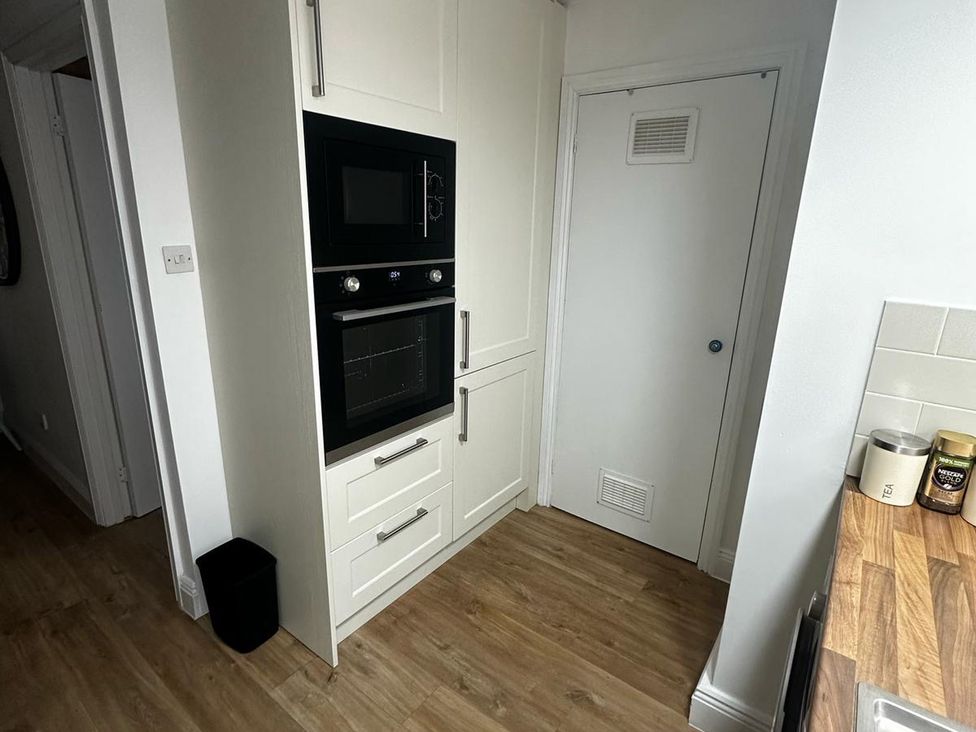 A kitchen with an oven and microwave at Claire Cottage