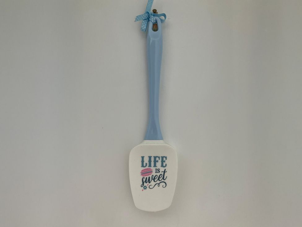 A spatula with the text 'LIFE is sweet' at Claire Cottage in 