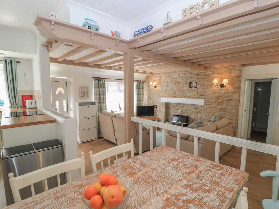 A dining room with a table and chairs at Claire Cottage in Swanage