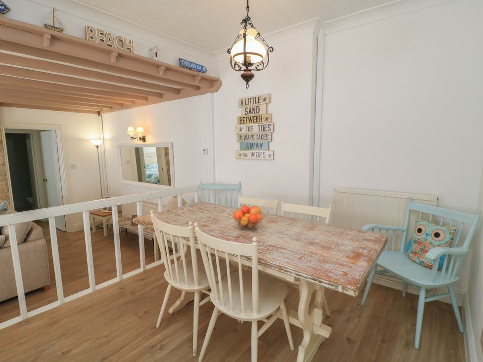 A dining room with a table and chairs at Claire Cottage in Swanage