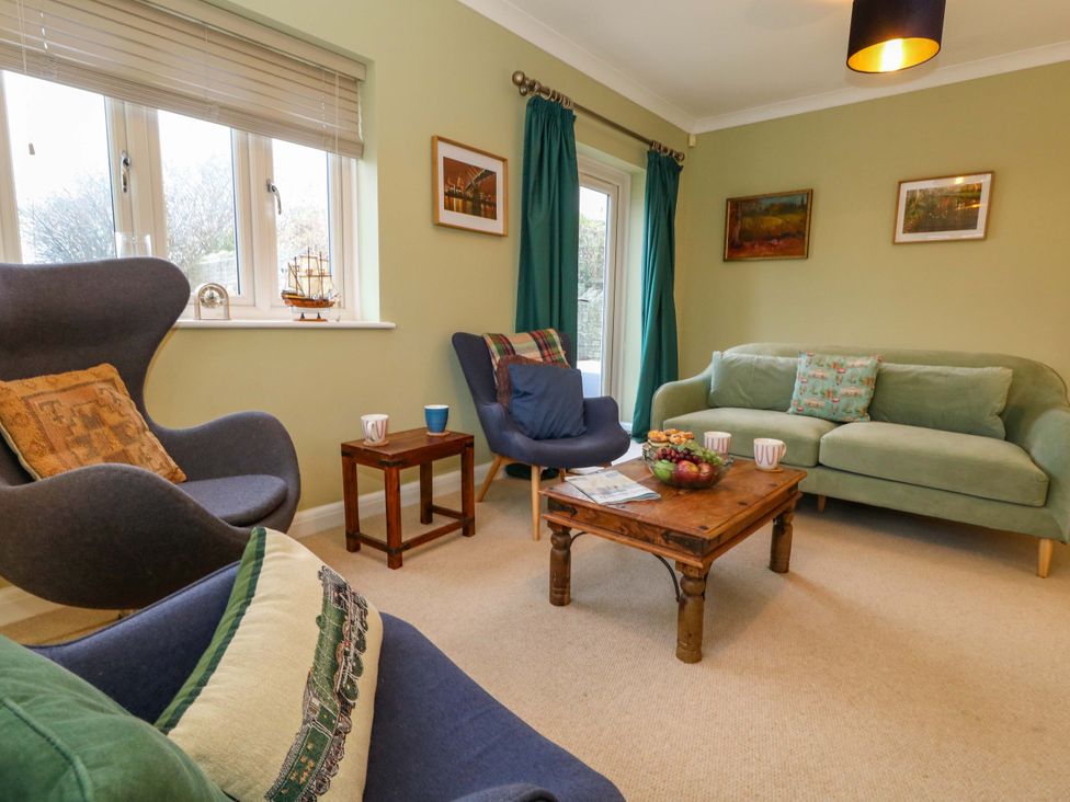 A living room with a couch and chairs at Corner Cottage Preston