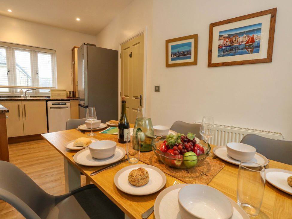A kitchen with a dining table set for a meal at Corner Cottage in Preston