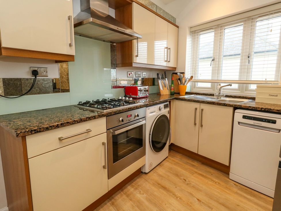 A kitchen with appliances and countertop at Corner Cottage Preston