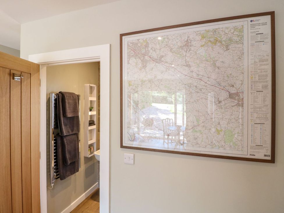 A map on the wall with a towel rack and towels in a bathroom at The Lodge at Middleton House Stoke-on-Trent