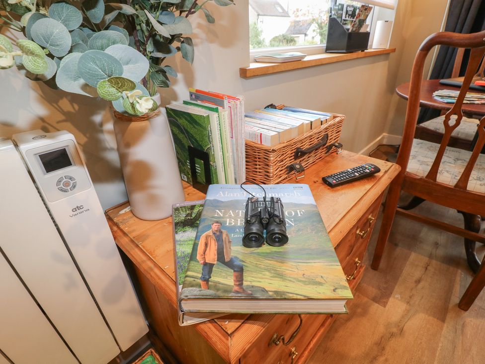 A living room with a binoculars and books on a table at The Lodge at Middleton House Middleton Green near Stone