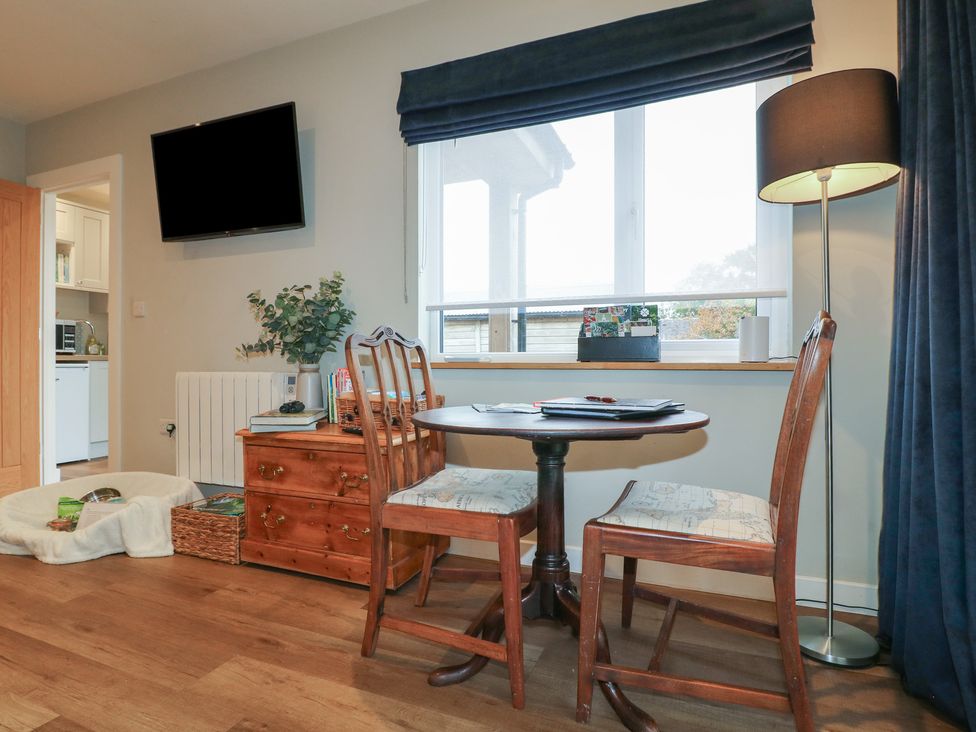 A dining area with a table and chairs at The Lodge at Middleton House Middleton Green near Stone