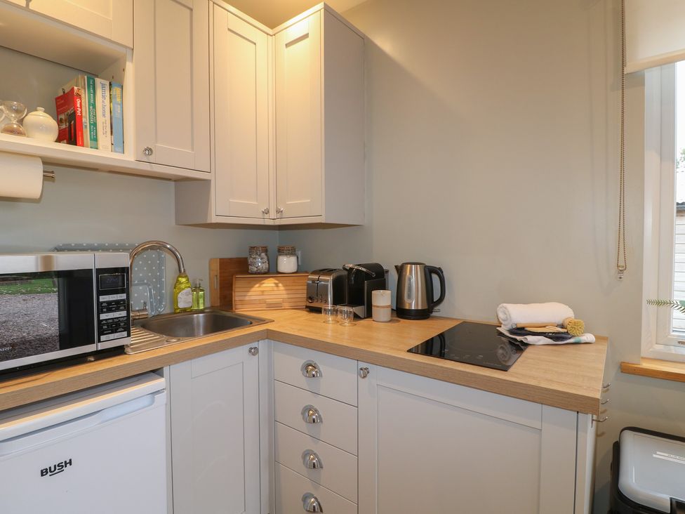A kitchen with a microwave, kettle, and sink at The Lodge at Middleton House Middleton Green near Stone
