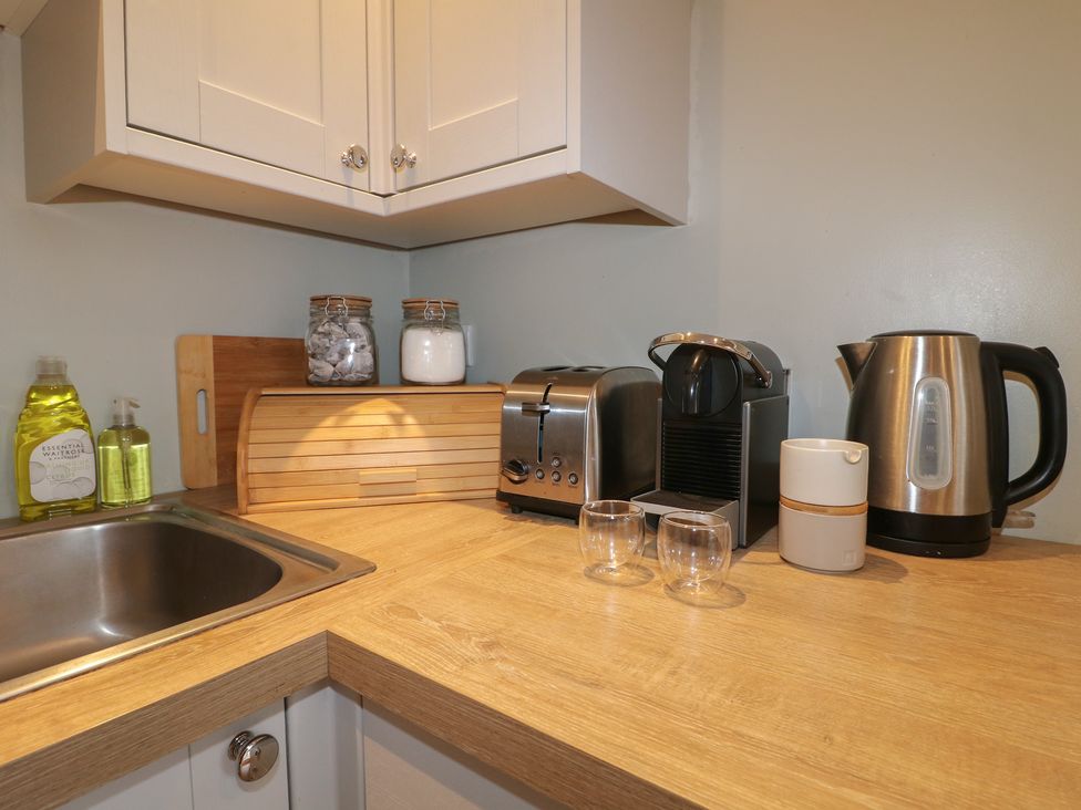 A kitchen counter with appliances and utensils at The Lodge at Middleton House Middleton Green near Stone