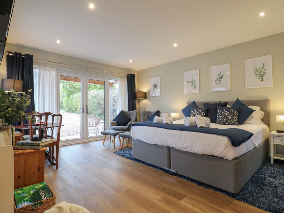 A bedroom with a bed and seating area at The Lodge at Middleton House Middleton Green near Stone