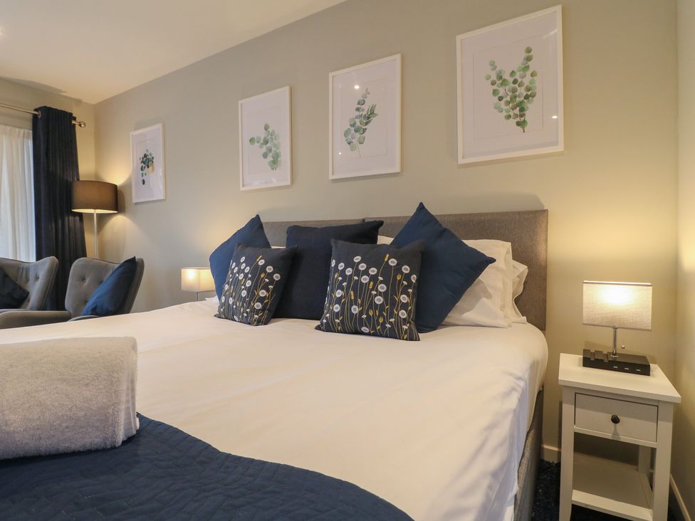 A bedroom with a bed and decorative pillows at The Lodge at Middleton House Middleton Green near Stone