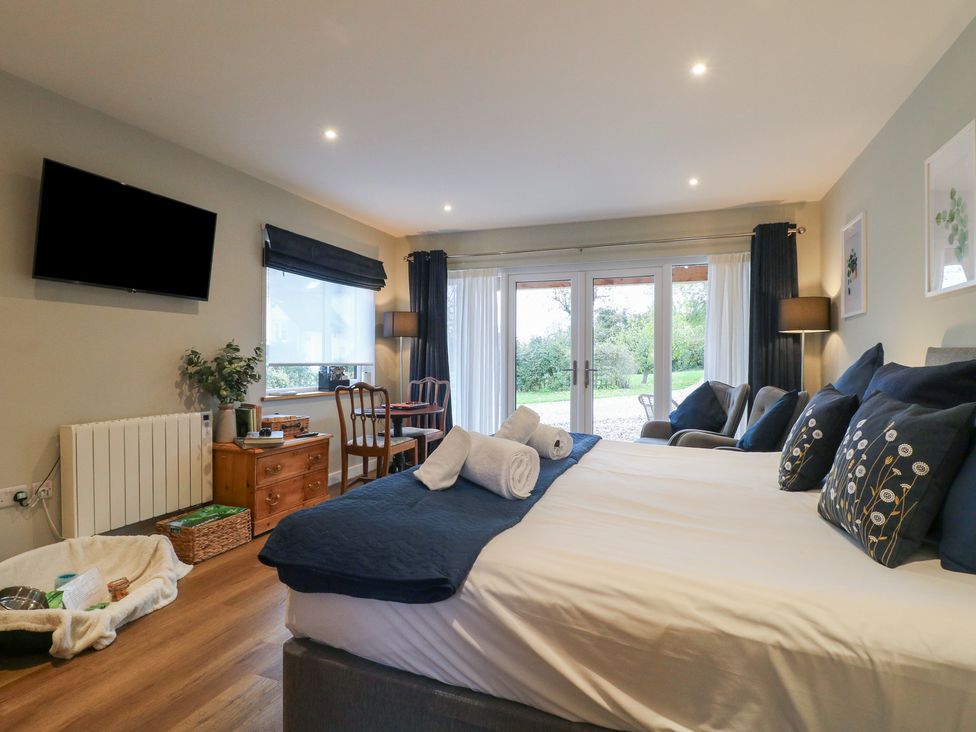 A bedroom with a bed and sofa at The Lodge at Middleton House Middleton Green near Stone