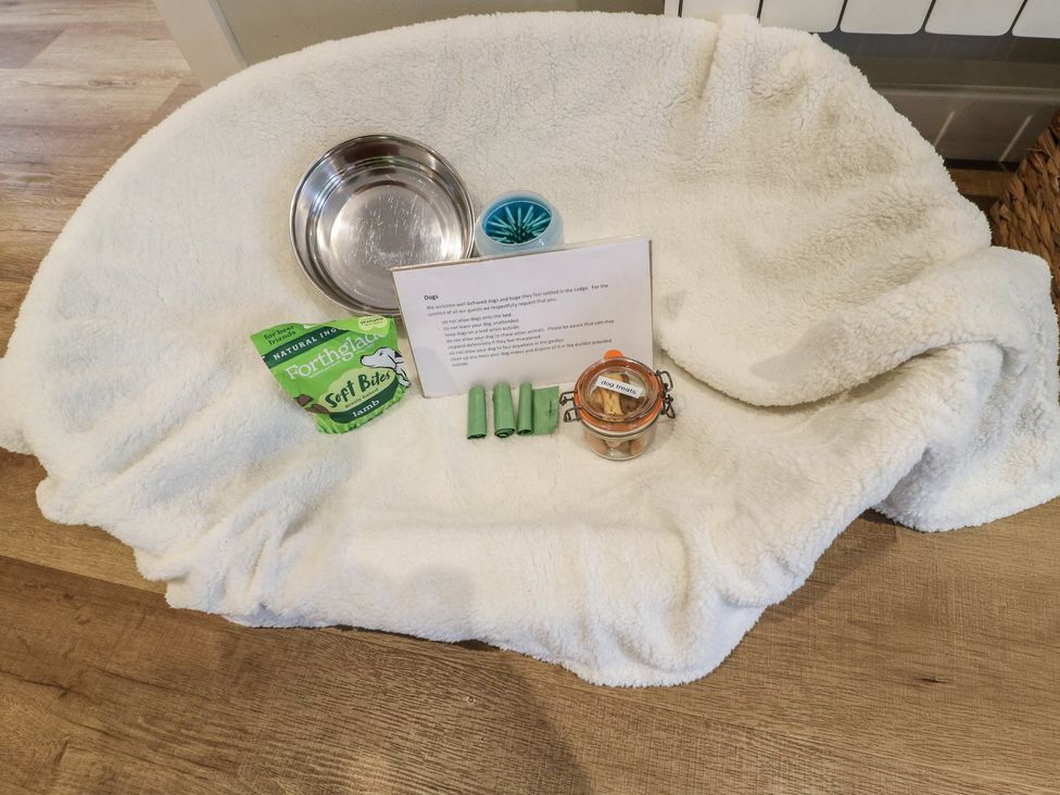A dog bed with dog bowl and treats at The Lodge at Middleton House Middleton Green near Stone