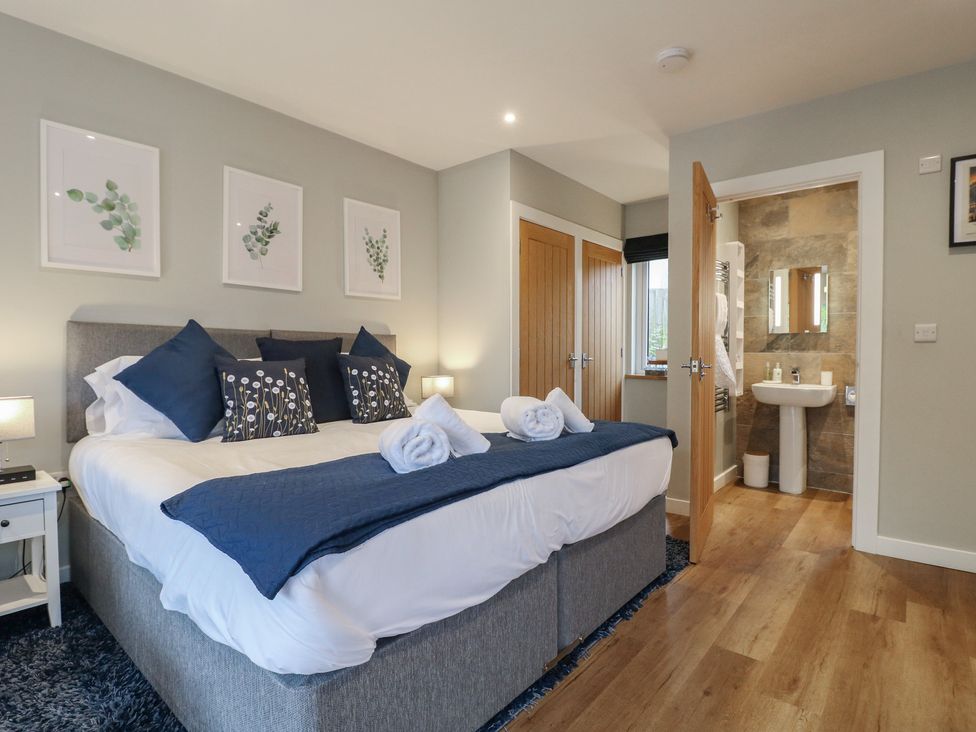 A bedroom with a bed and attached bathroom at The Lodge at Middleton House Middleton Green near Stone