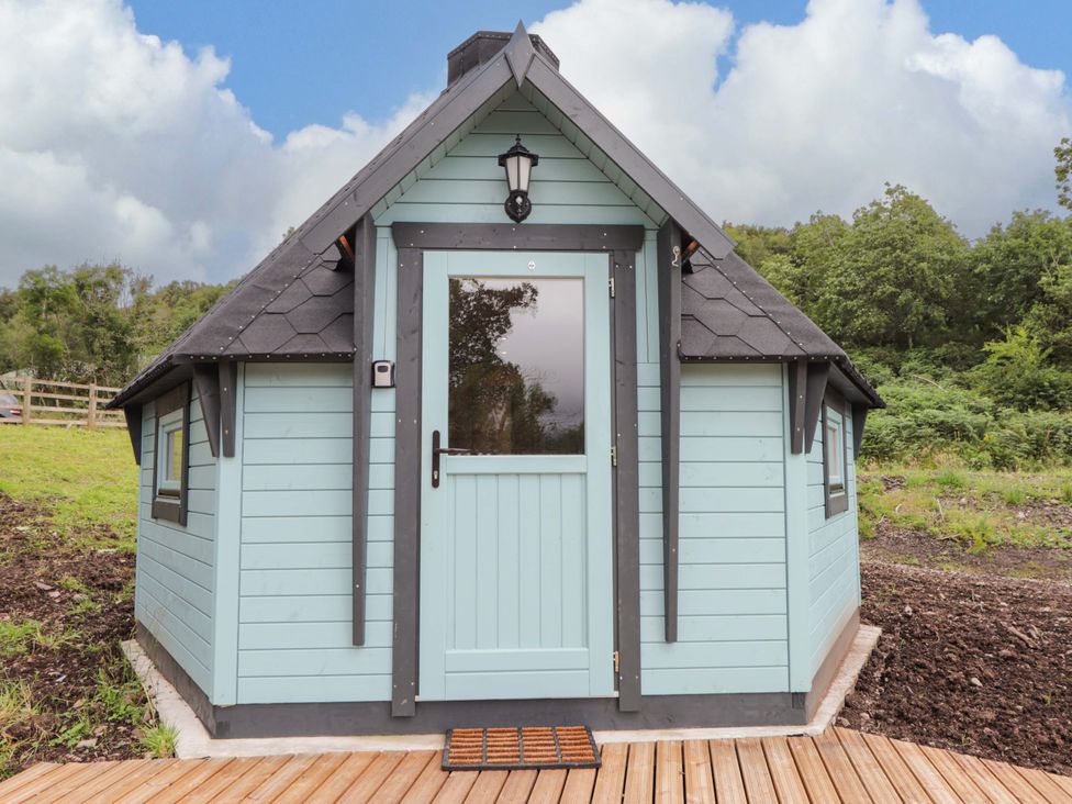 A cabin with a door and windows at Little Luxe Lodges Balmacara near Kyle of Lochalsh