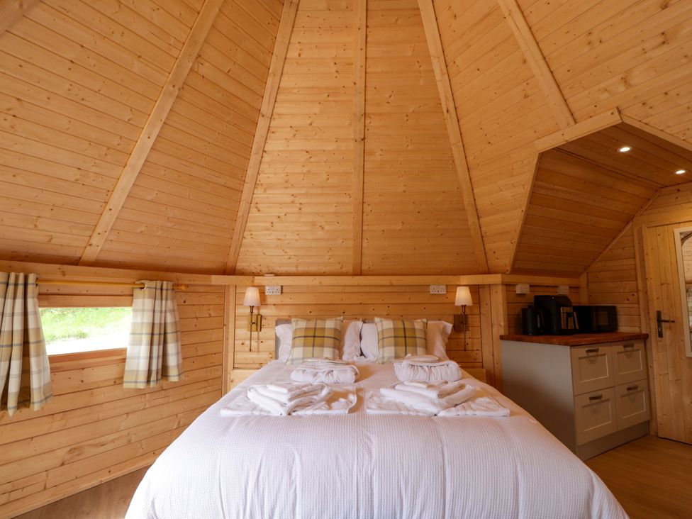A bedroom with a bed and kitchenette at Little Luxe Lodges Balmacara near Kyle of Lochalsh