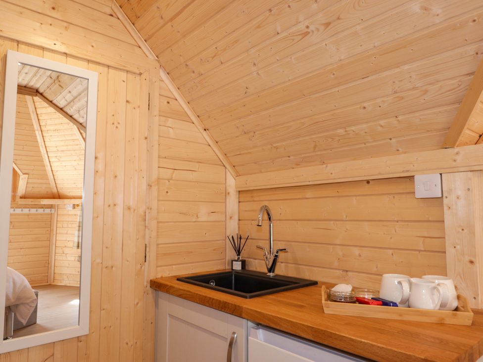 A kitchen with a sink and mirror at Little Luxe Lodges Balmacara near Kyle of Lochalsh