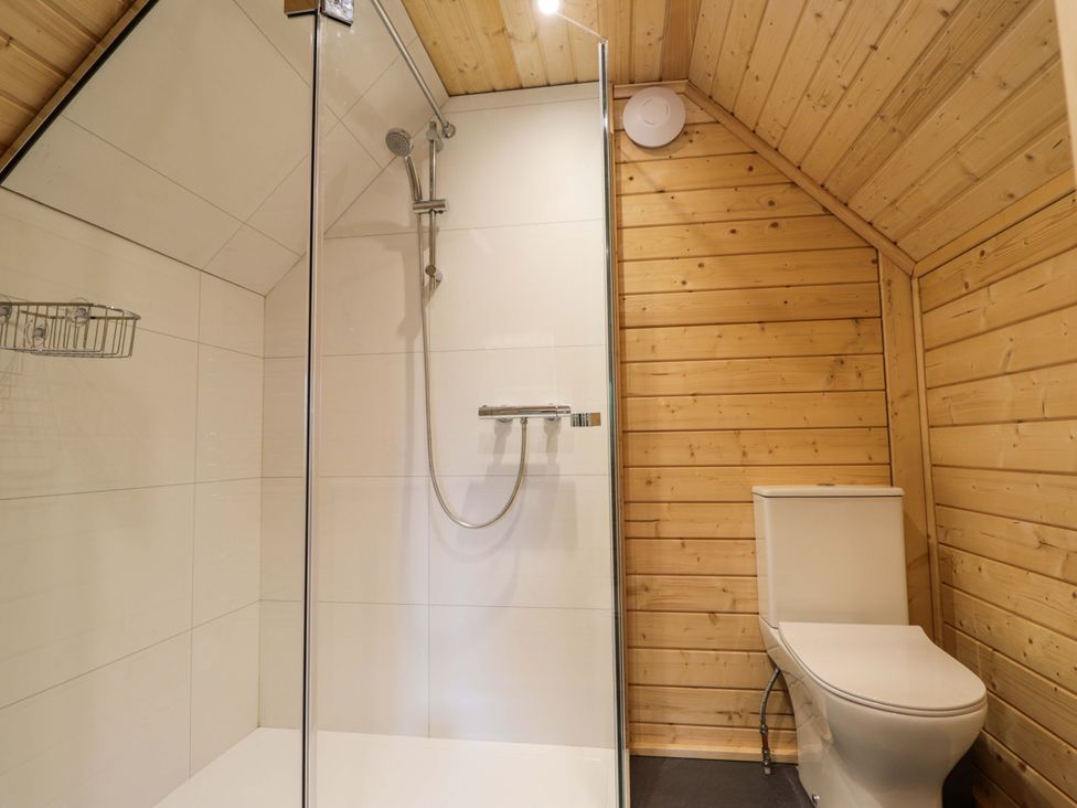A bathroom with a shower and toilet at Little Luxe Lodges Balmacara near Kyle of Lochalsh